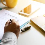 businessman Reading job description paper In office. businessman Reading job description paper In office.