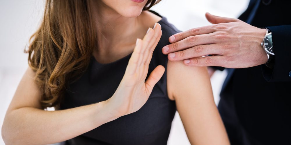 Businessman Sexually Harassing Female Colleague At Work
